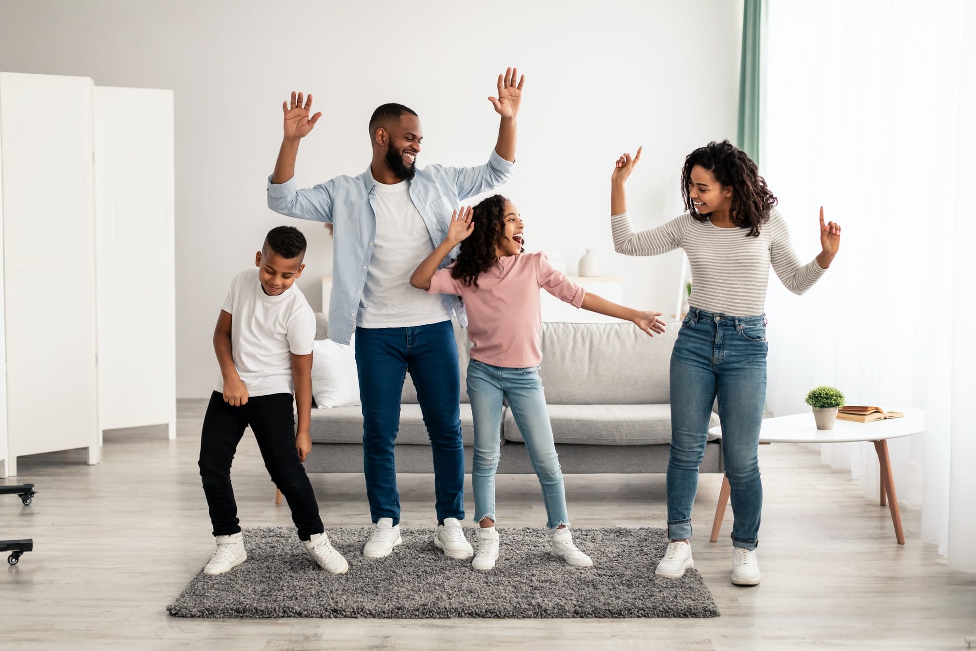 African american parents dancing to music with little children