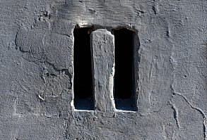 Back and forth. Drawn on the wall next to two holes on the wall that look like a pause icon.
